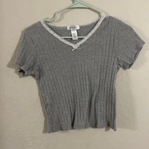 A gray cropped shirt with a lace neck
